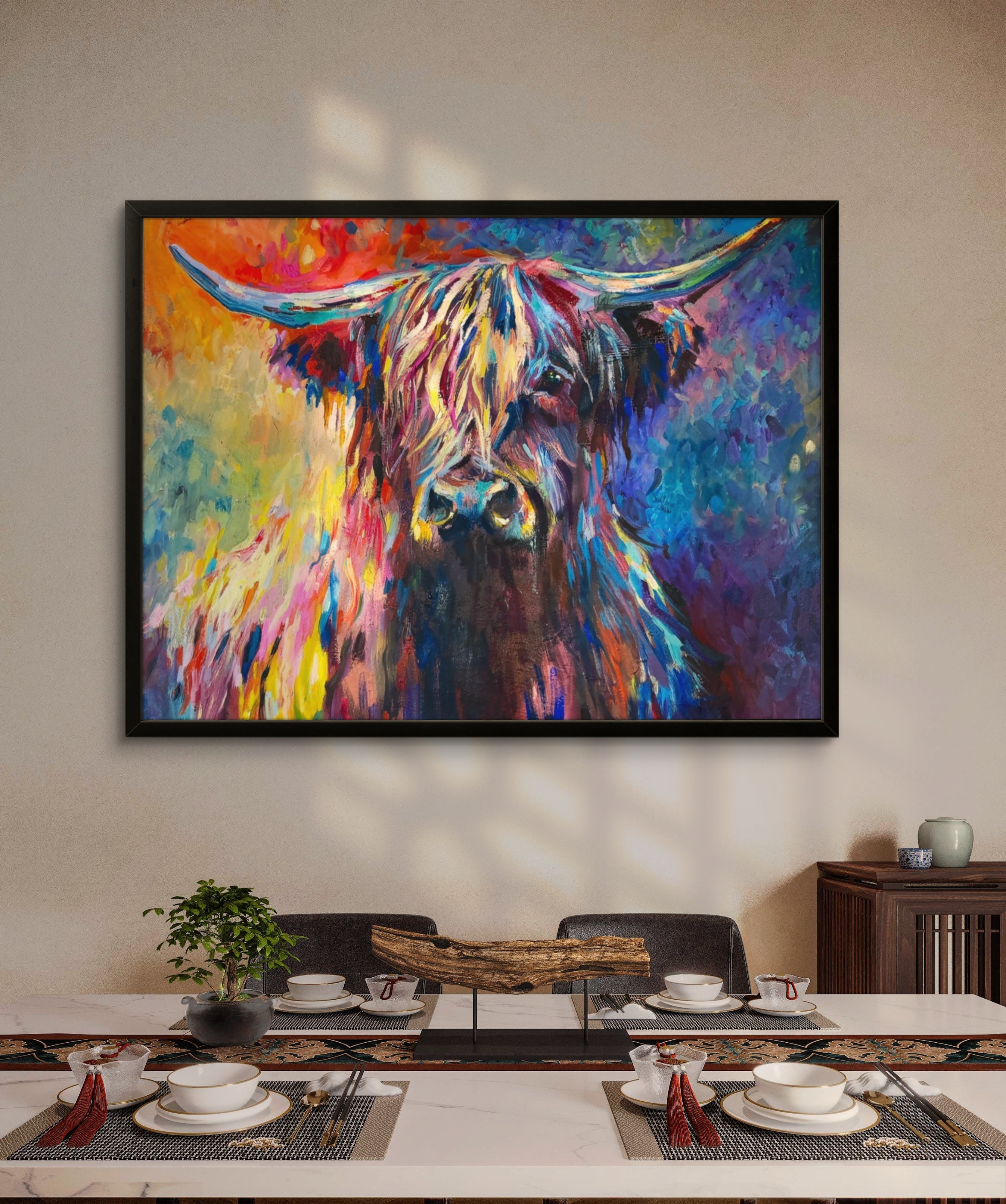 Colorful abstract painting of a cow on a wall above a dining table.