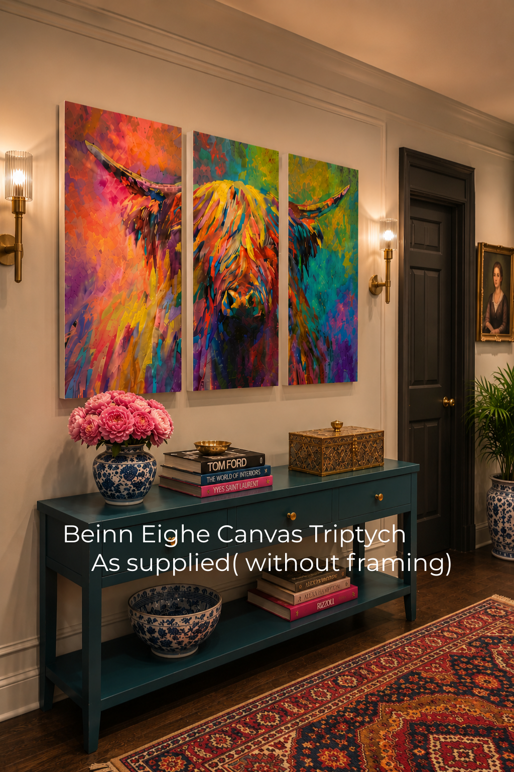 Colorful triptych painting of a highland cow on a wall above a blue console table with decorative items.