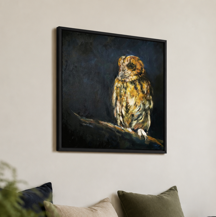 A framed canvas painting of a detailed owl perched on a branch, displayed on a light beige wall above a sofa with decorative pillows and vases.