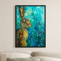 A framed vertical art print featuring a colorful painted hare in profile against a vivid blue and green floral background, hanging on a light beige wall above a sofa.