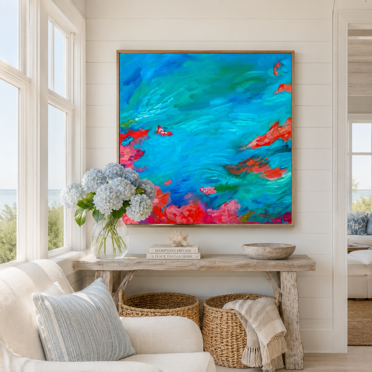 Colorful abstract painting on a wall above a wooden console table with decor items in a living room.