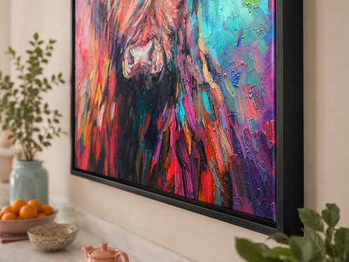 Colorful abstract painting on a wall in a room with plants and a bowl of oranges.