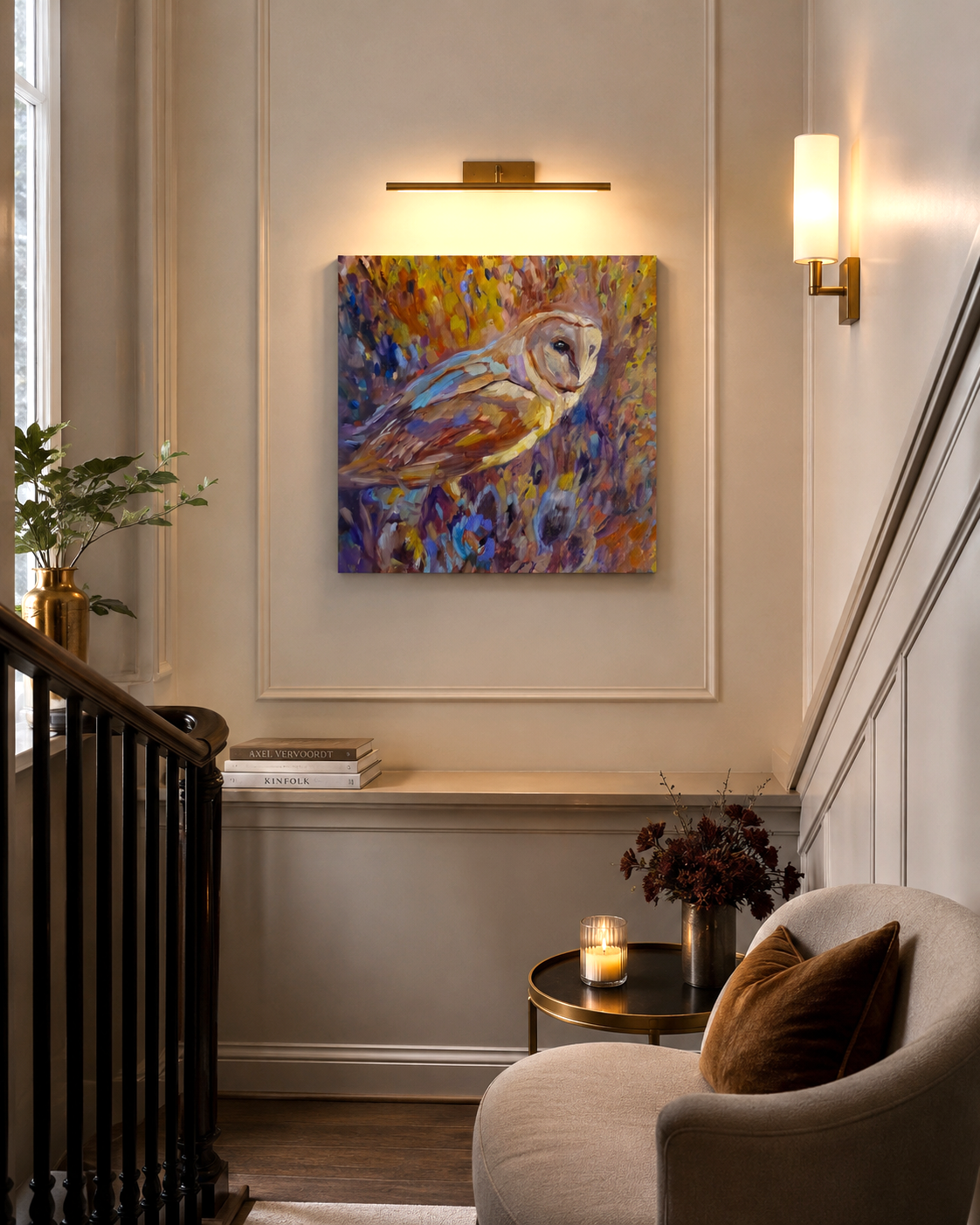 Staircase with a colorful owl painting on the wall, a candle on a table, and a plant.