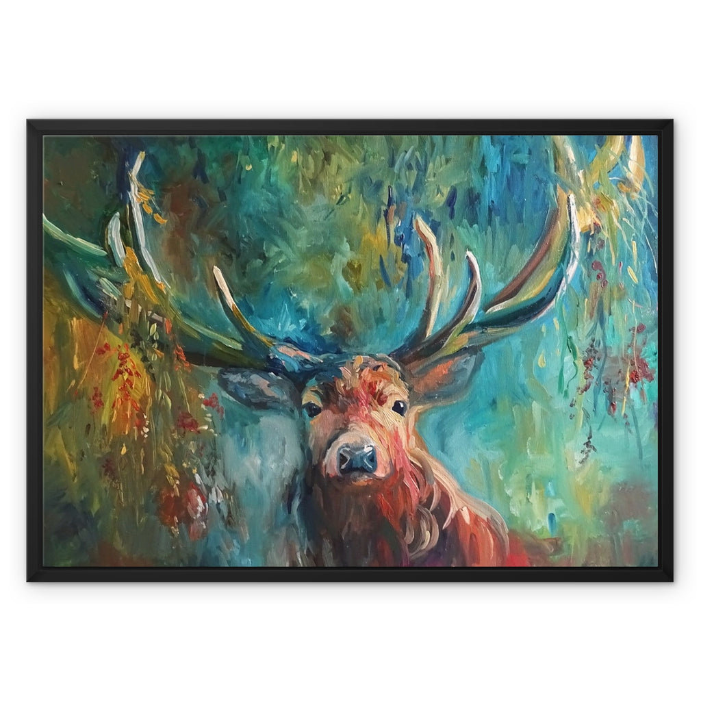 Framed canvas wall art featuring an expressive painting of a stag with large antlers against a vivid teal, green, and gold forest background, shown in a black frame on a white background.