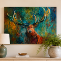 A colorful canvas painting of a stag with large antlers hangs on a cream-colored wall above a light wood console table in a styled entryway. The painting features rich blues, greens, and warm brown and orange tones.