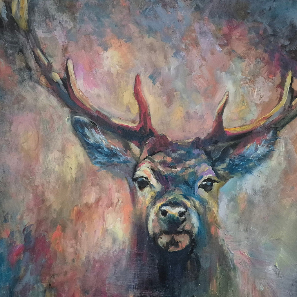 Colorful painting of a deer with large antlers on a plain wall.