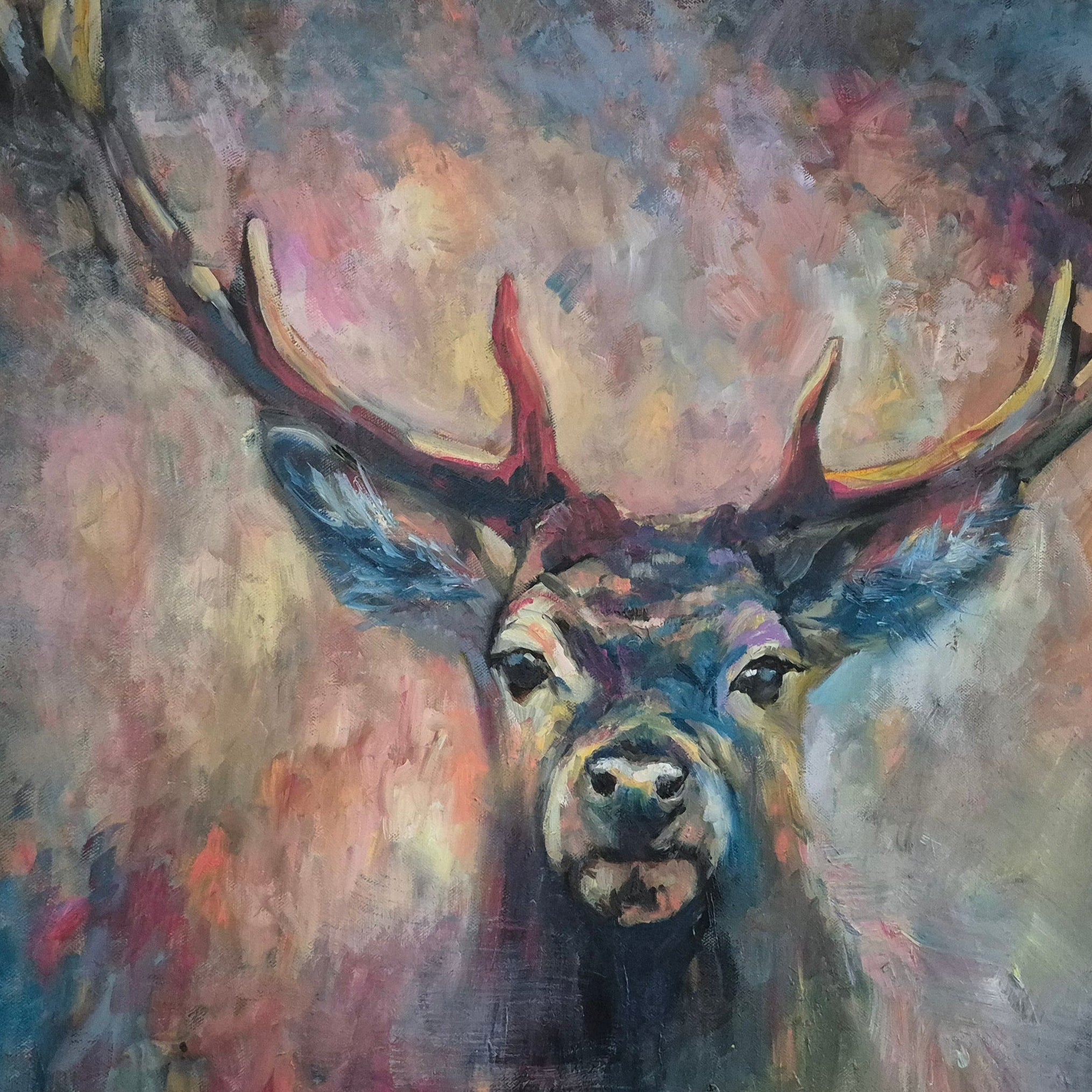 Colorful painting of a deer with large antlers on a plain wall.