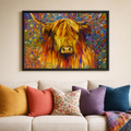 A framed colorful painting of a Highland cow hanging on a beige wall above a white sofa with multiple decorative throw pillows.