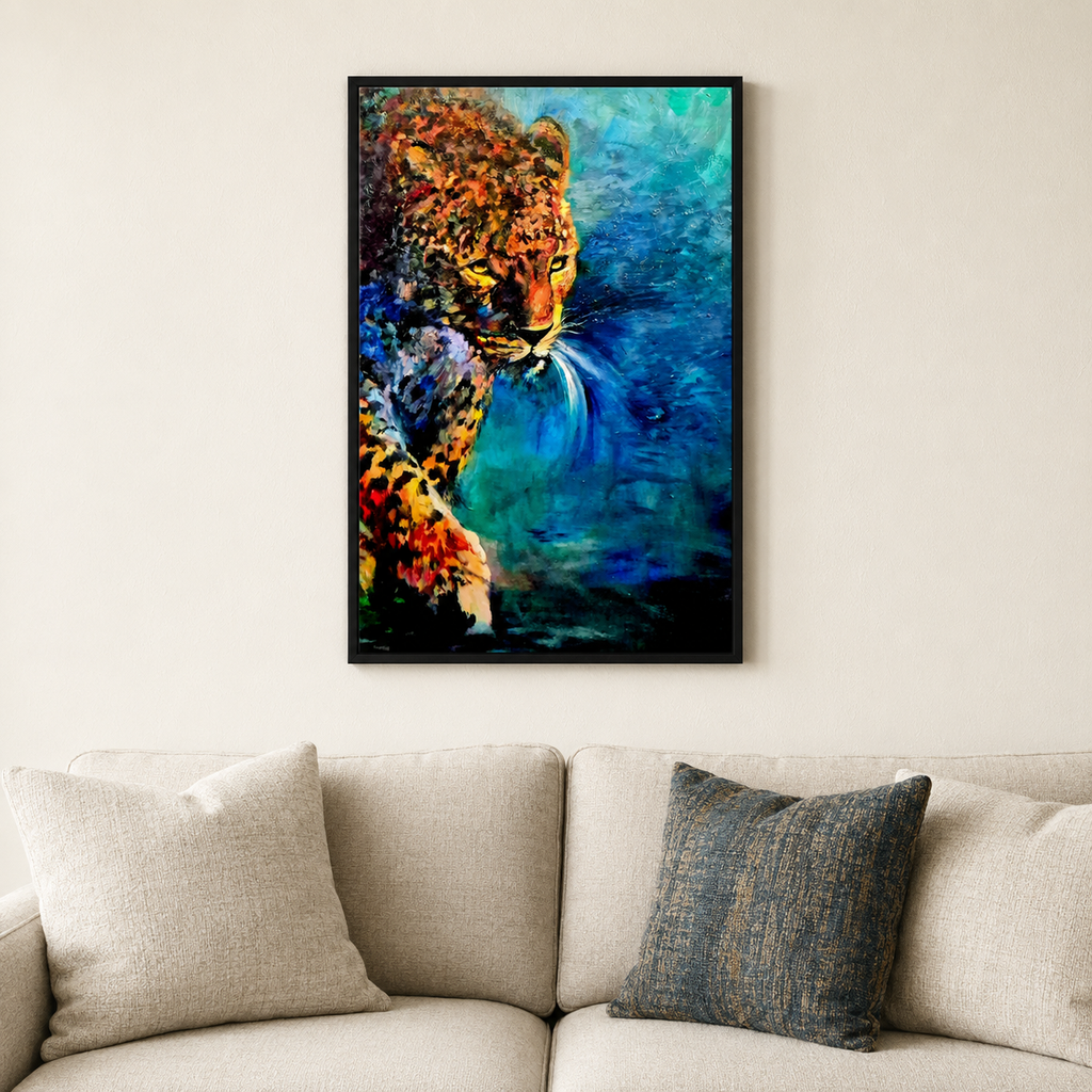 A framed vertical canvas art print depicting a colorful leopard in profile against a blue and teal background, hanging on a beige wall above a light beige sofa with pillows.