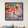 A colorful framed canvas painting of an octopus hanging on a light beige wall above a white sofa with decorative pillows.