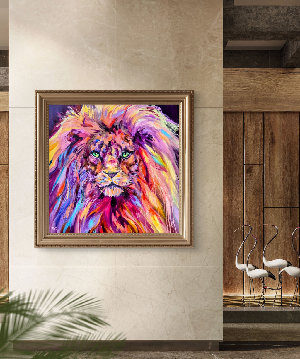Colorful lion painting in a gold frame on a wall.