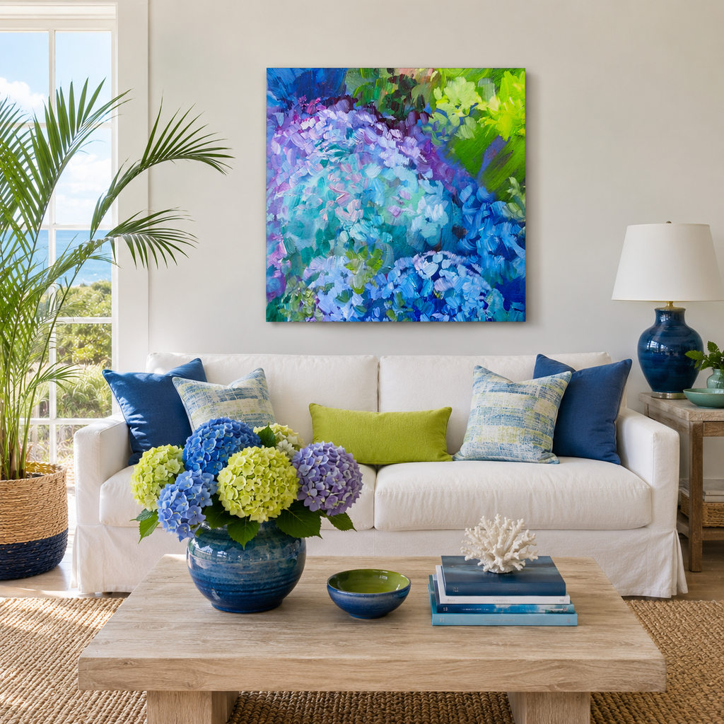 A colorful abstract floral canvas print in shades of blue, purple, and green hangs on a white wall above a white sofa in a bright, modern living room.