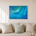 An abstract canvas wall art print featuring vibrant swirls of blue and green, displayed on a beige wall above a modern beige sofa with decorative pillows.