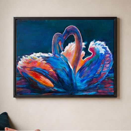 A framed colorful painting of two swans facing each other, hanging on a beige wall. The artwork features vibrant blue, purple, orange, and red brushstrokes, enclosed in a black frame.